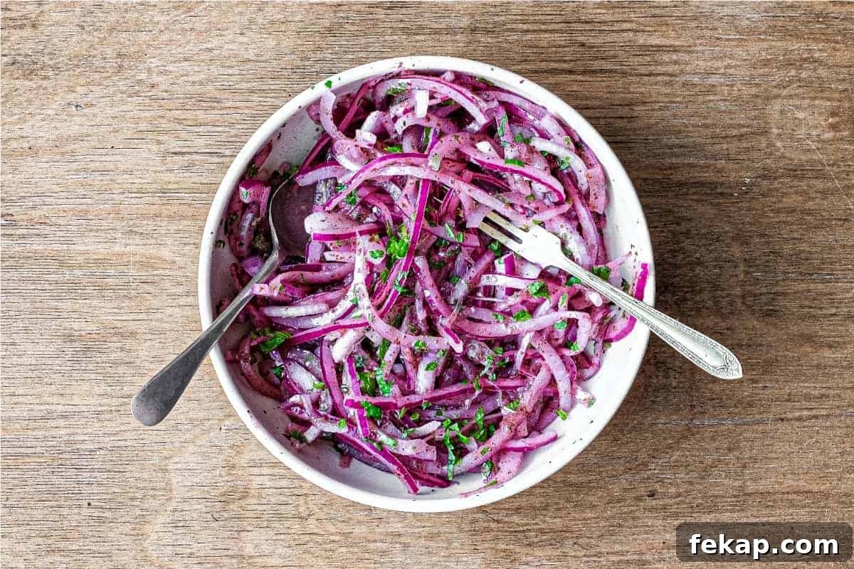 Sumac Pickled Onions for Salads, Tacos and Sandwiches 2 A small bowl of Sumac Onions with a small serving fork and spoon