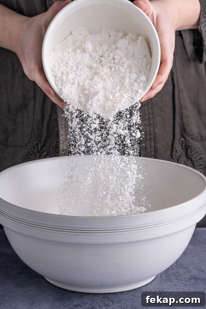 Adding half bread flour and half all-purpose flour to pretzel dough.