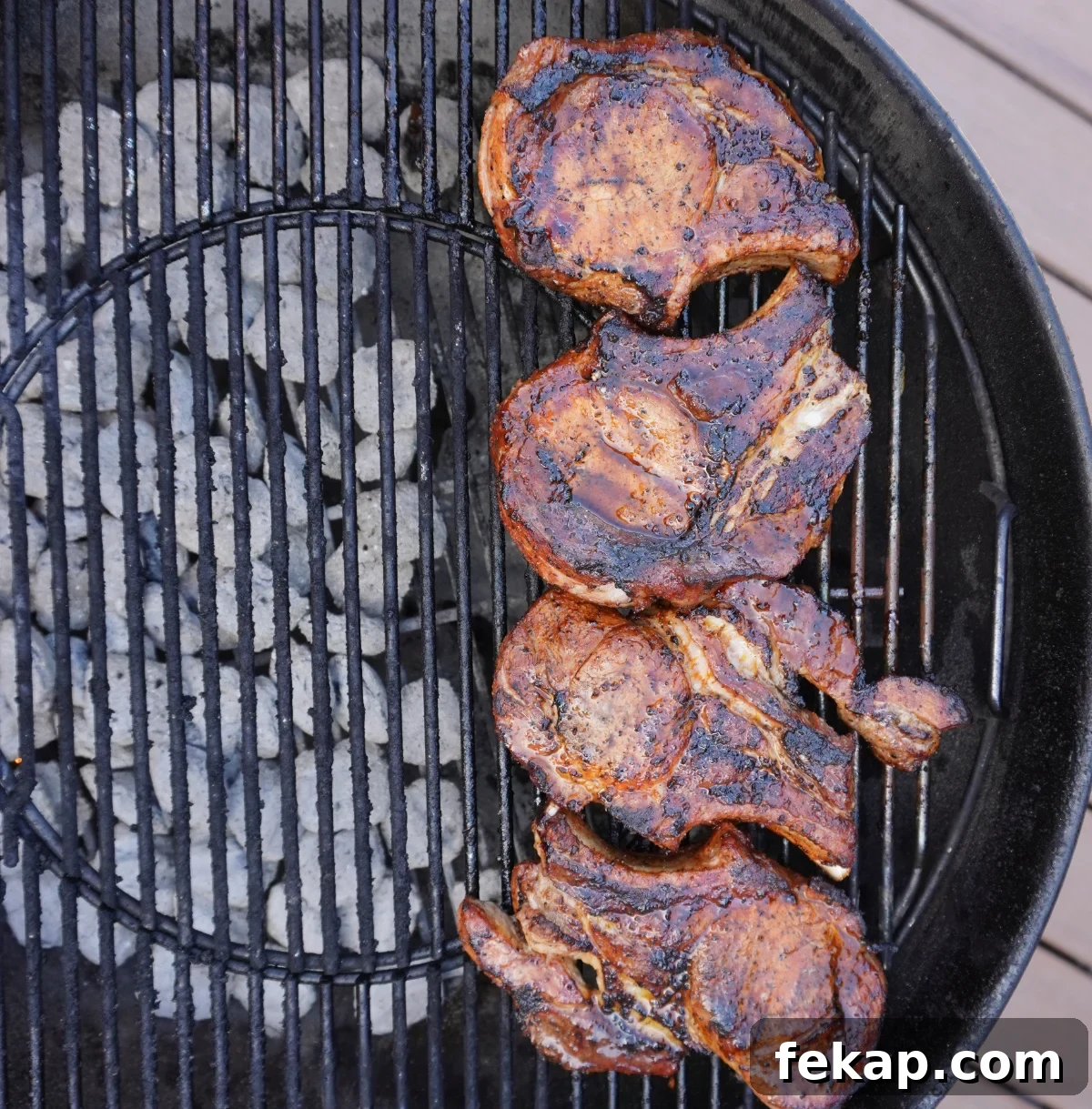 Juicy Grilled Pork Chops with Garlic Herb Marinade 5 Pork chops grilling over hot grates