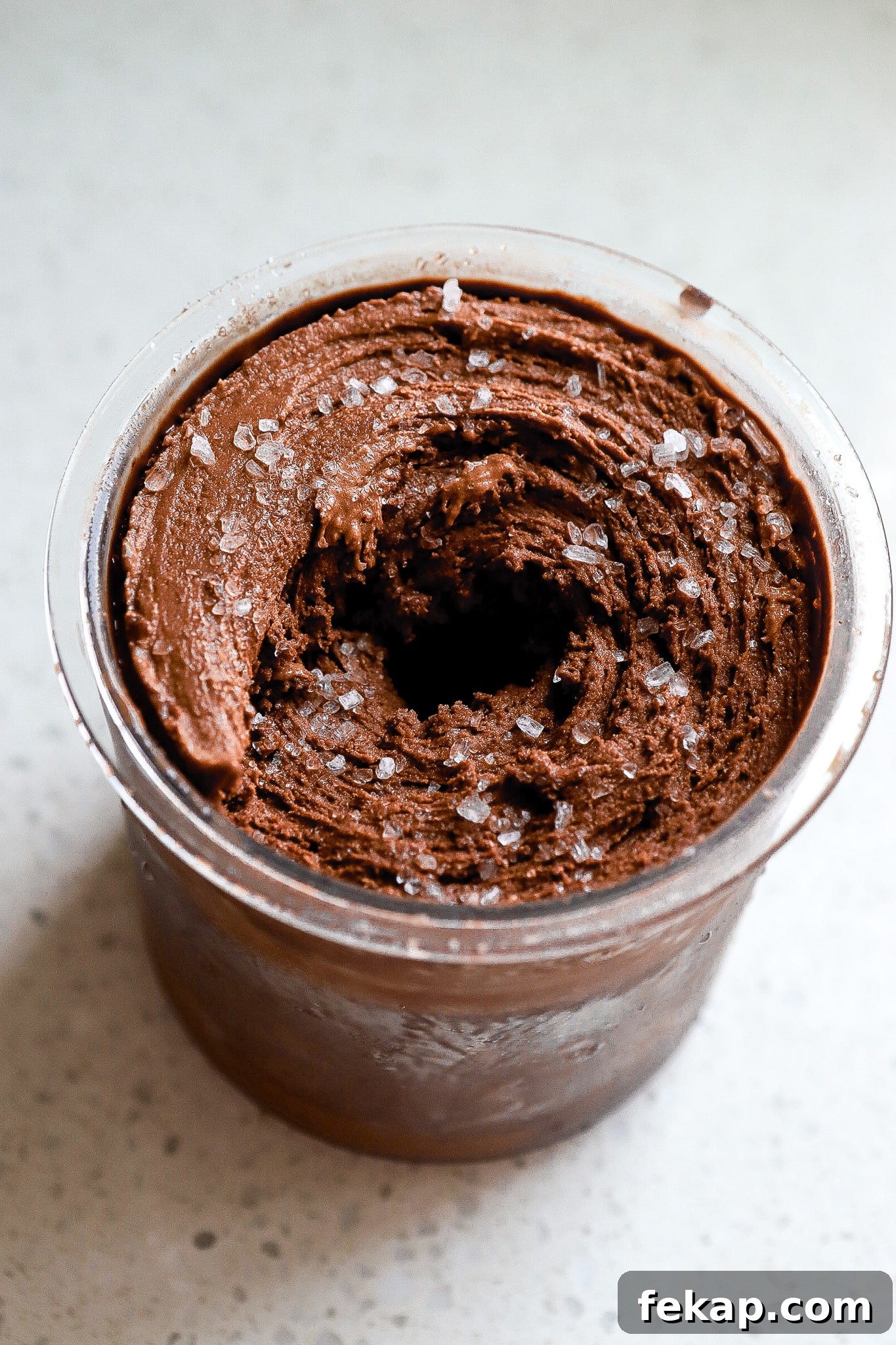 Ninja Creami Salted Chocolate Protein Ice Cream Recipe 3 Side angle of creamy chocolate ice cream in ninja creami pint.