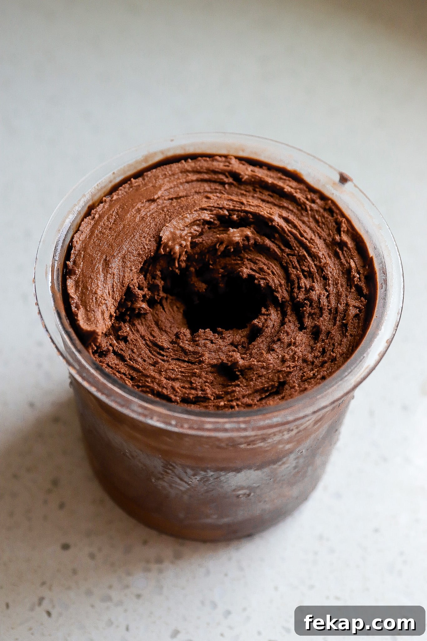 Ninja Creami Salted Chocolate Protein Ice Cream Recipe 4 Side view of salted chocolate ice cream in ninja creami pint.