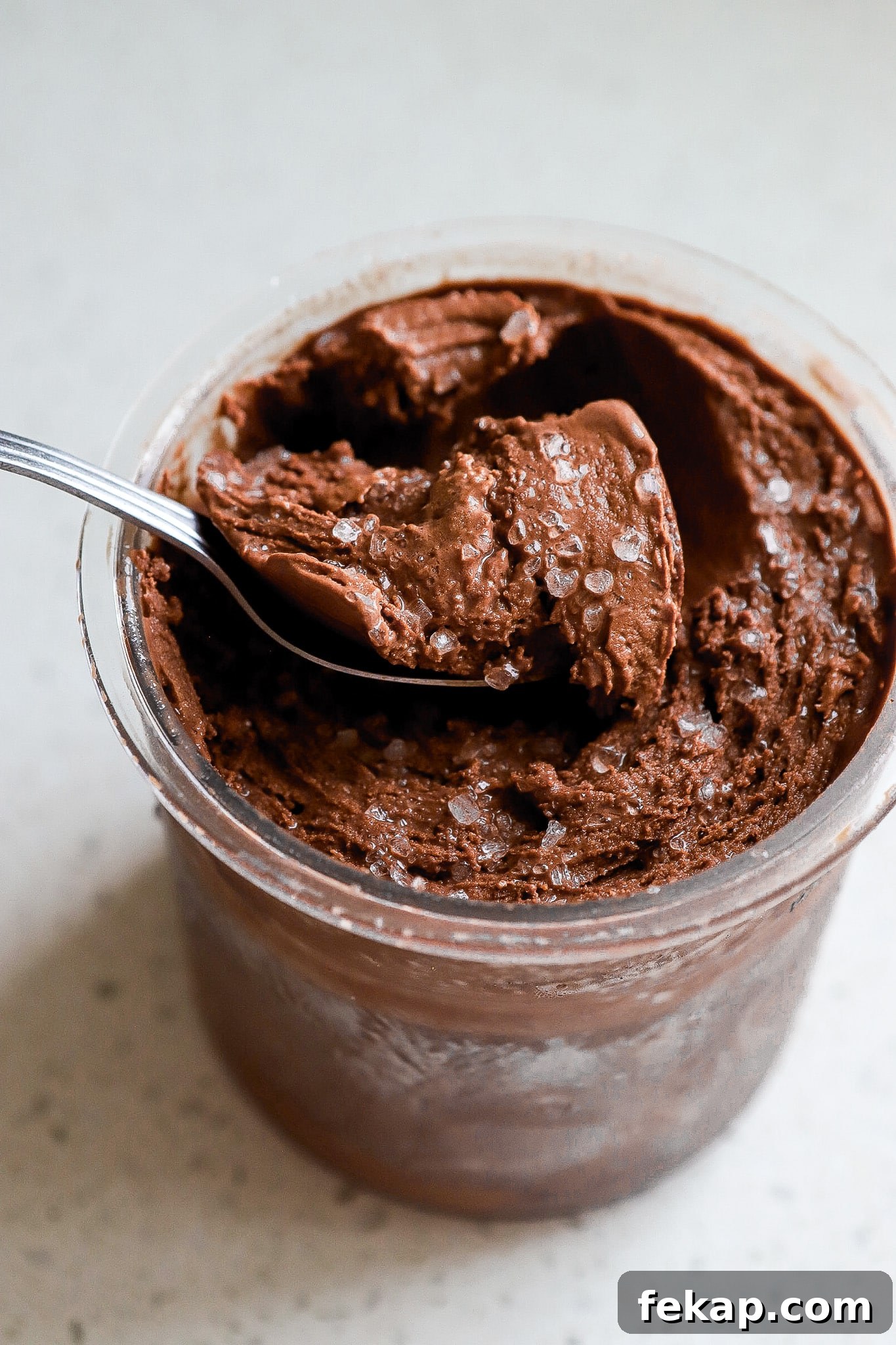Ninja Creami Salted Chocolate Protein Ice Cream Recipe 6 Spoonful of homemade chocolate ice cream with flaky sea salt.