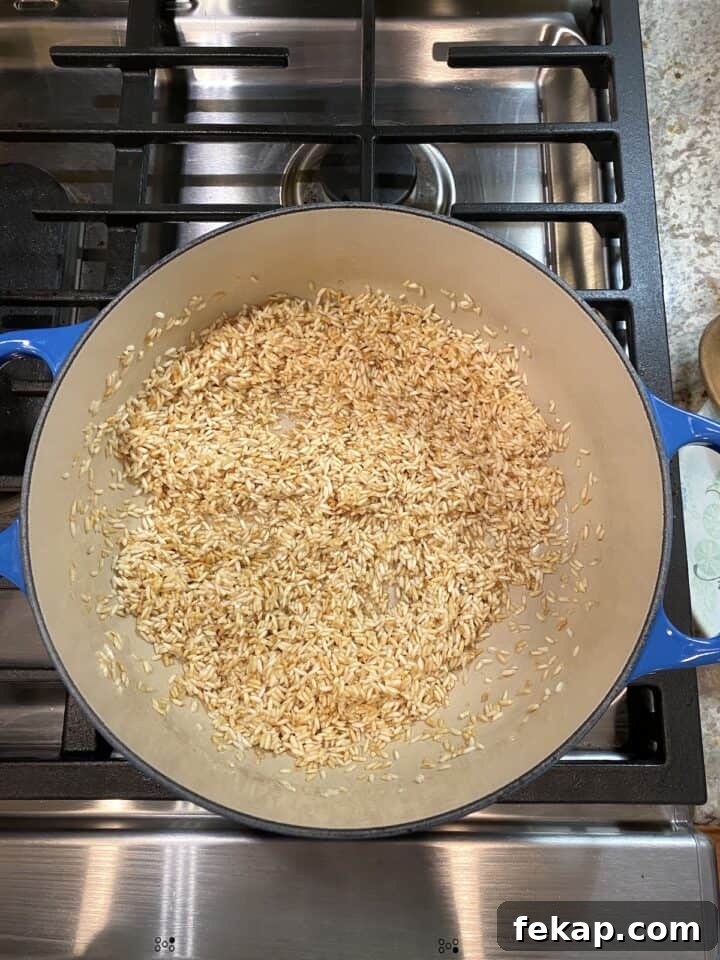Restaurant-Style Mexican Fried Rice Recipe 12 A pot of rice browned in oil.