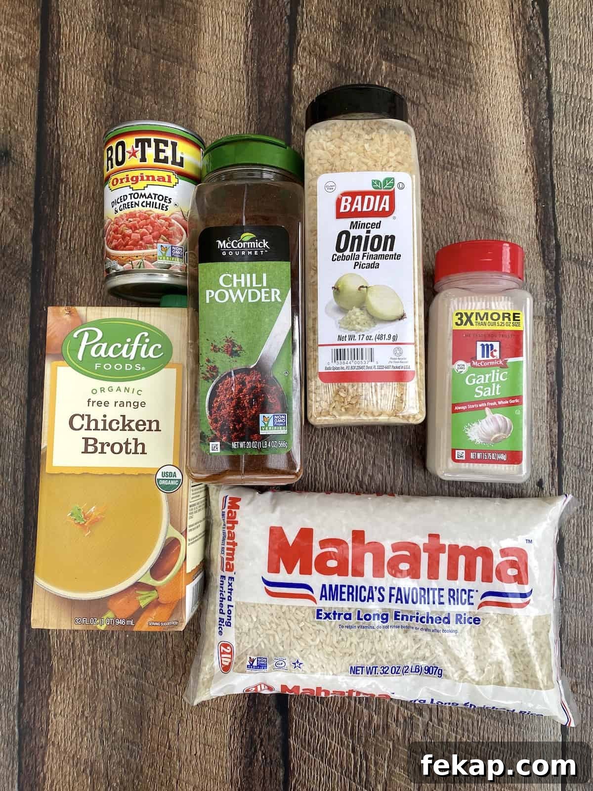 Restaurant-Style Mexican Fried Rice Recipe 3 Ingredients for Mexican rice displayed on wooden table.