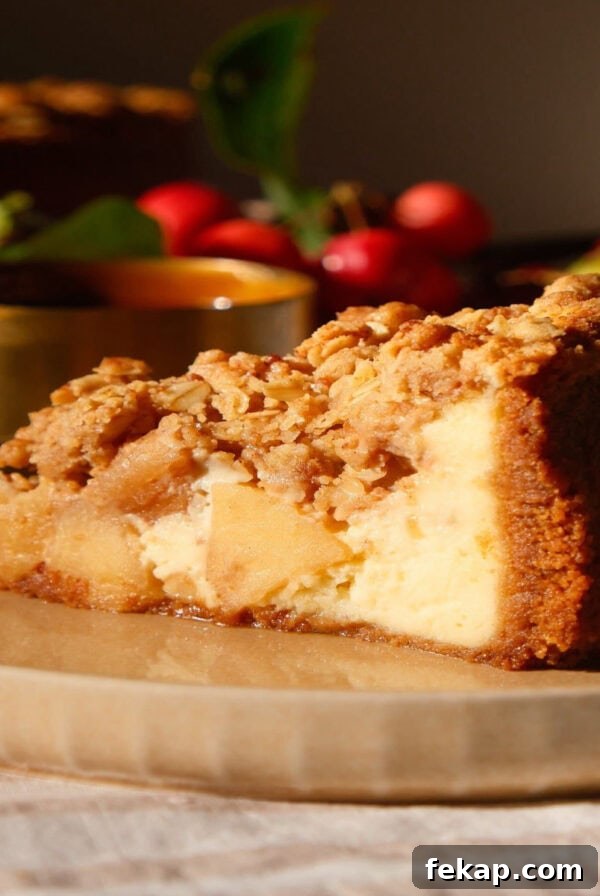 slice of apple crumble cheesecake on a beige plate.