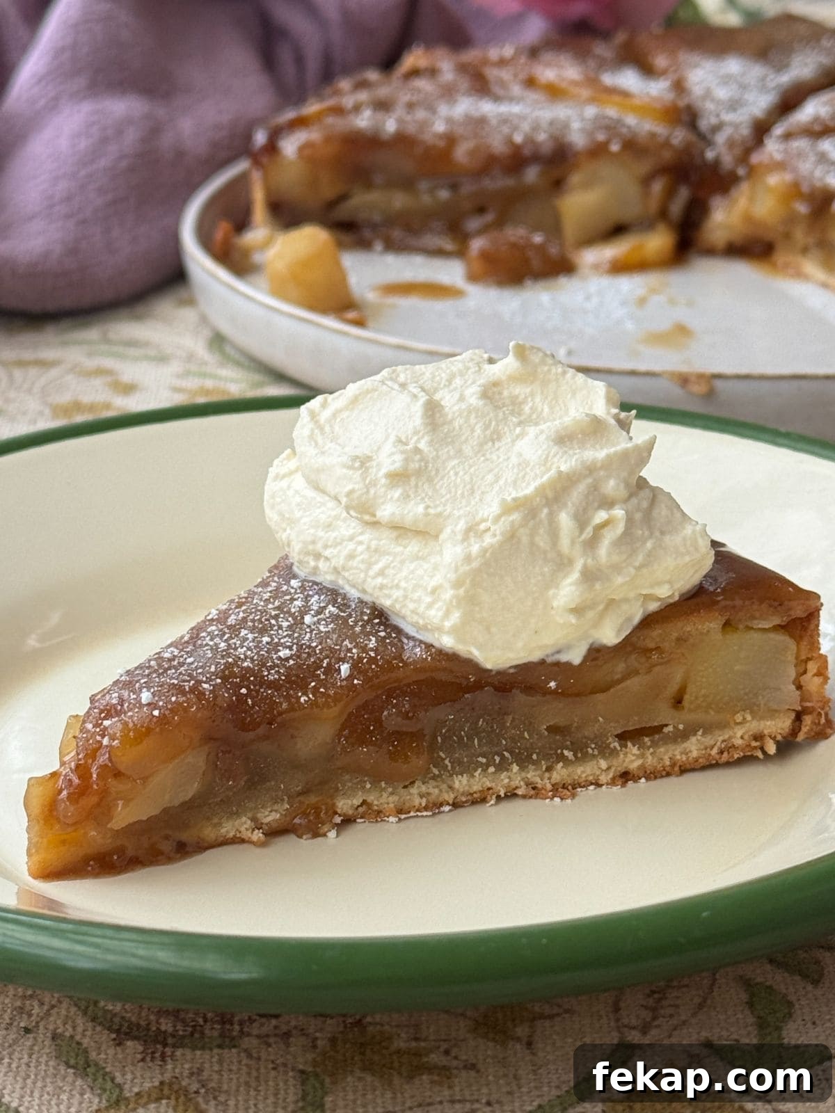 Pear Upside-Down Cake with Warm Fudge Sauce 3 pear upside down cake topped with whipped cream.