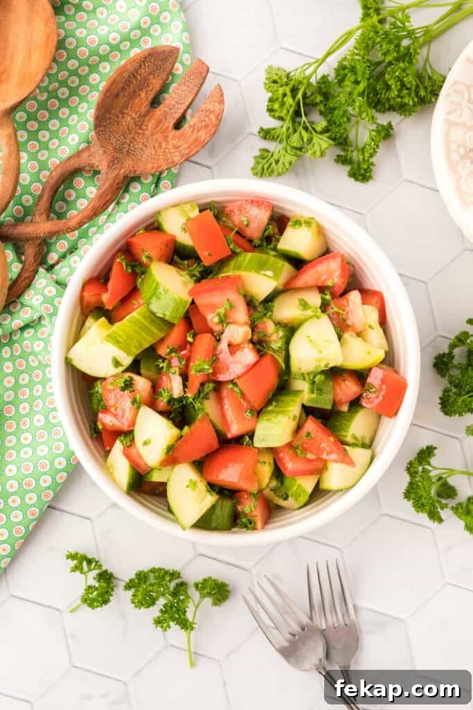Tomatoes, cucumber and parsley in a salad bowl.