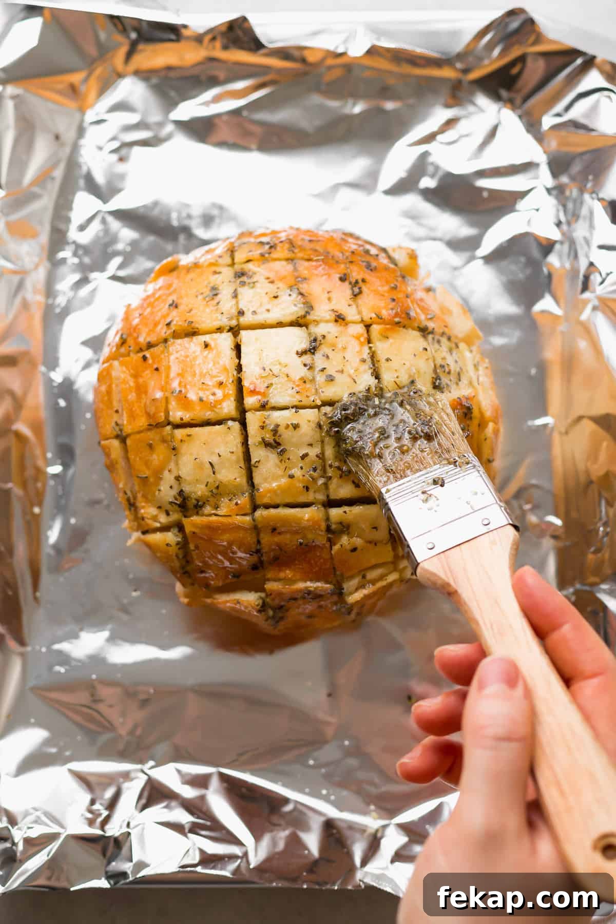 painting on garlic butter onto bread