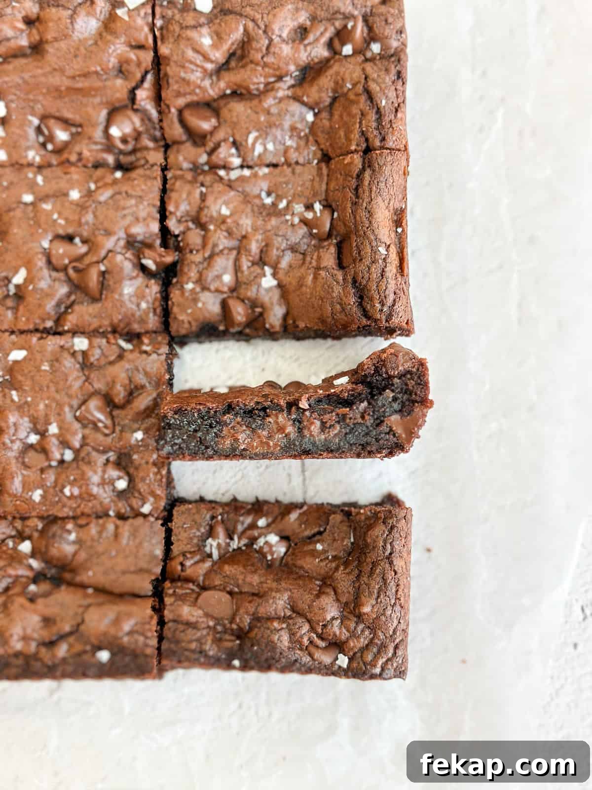 Fudgy Double Chocolate Cookie Bars Recipe 2 double chocolate cookie bars cut and one turned on its side to see the inside texture.