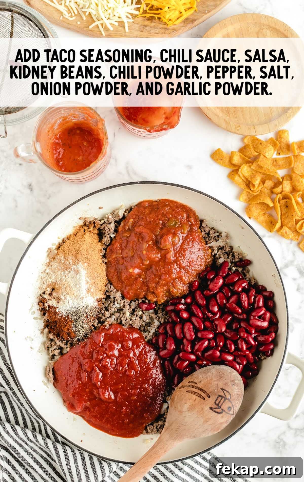 Frito Pie Casserole Recipe: Baked Chili and Cheese 5 taco seasoning, chili sauce, salsa, kidney beans, chili powder, pepper, salt, onion powder, and garlic powder added to the ground beef mixture