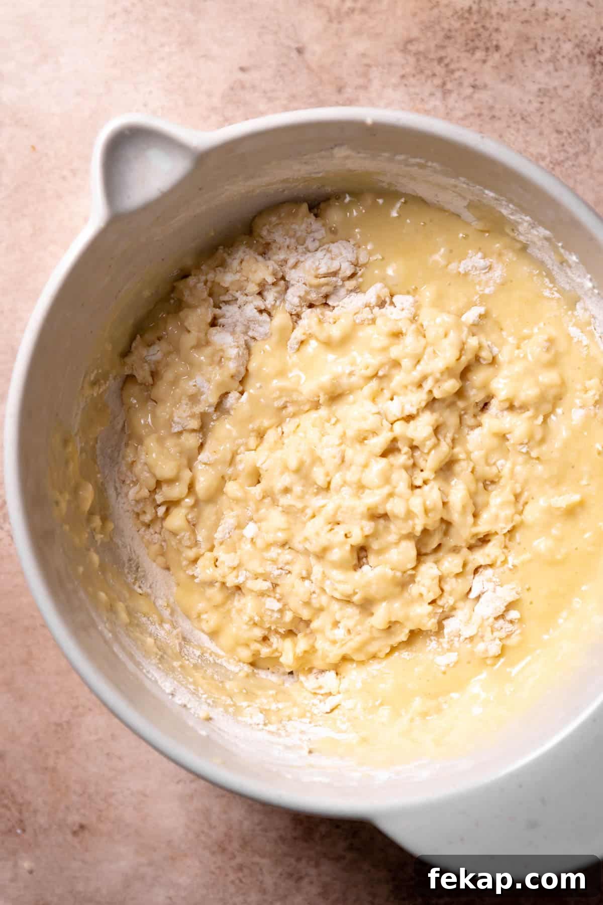 Fluffy Cinnamon Roll Muffins with Cream Cheese Icing Recipe 4 A mixing bowl with the muffin batter ingredients mixed together with some dry flour remaining.