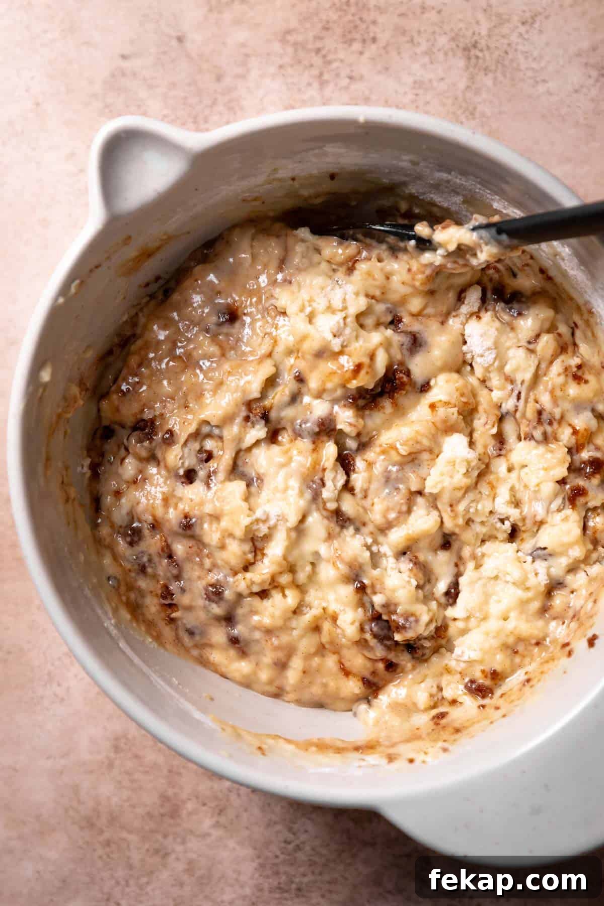 Fluffy Cinnamon Roll Muffins with Cream Cheese Icing Recipe 5 A mixing bowl with the cinnamon swirled muffin batter.