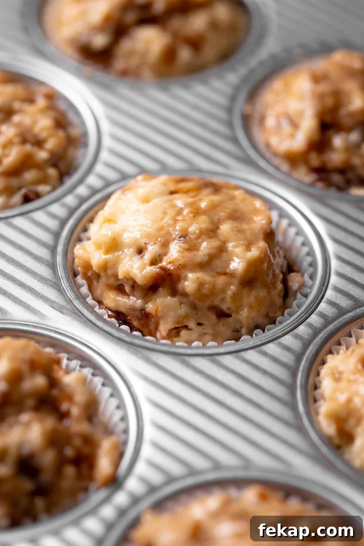 Fluffy Cinnamon Roll Muffins with Cream Cheese Icing Recipe 6 A muffin pan with the cinnamon batter scooped into the muffin liners.