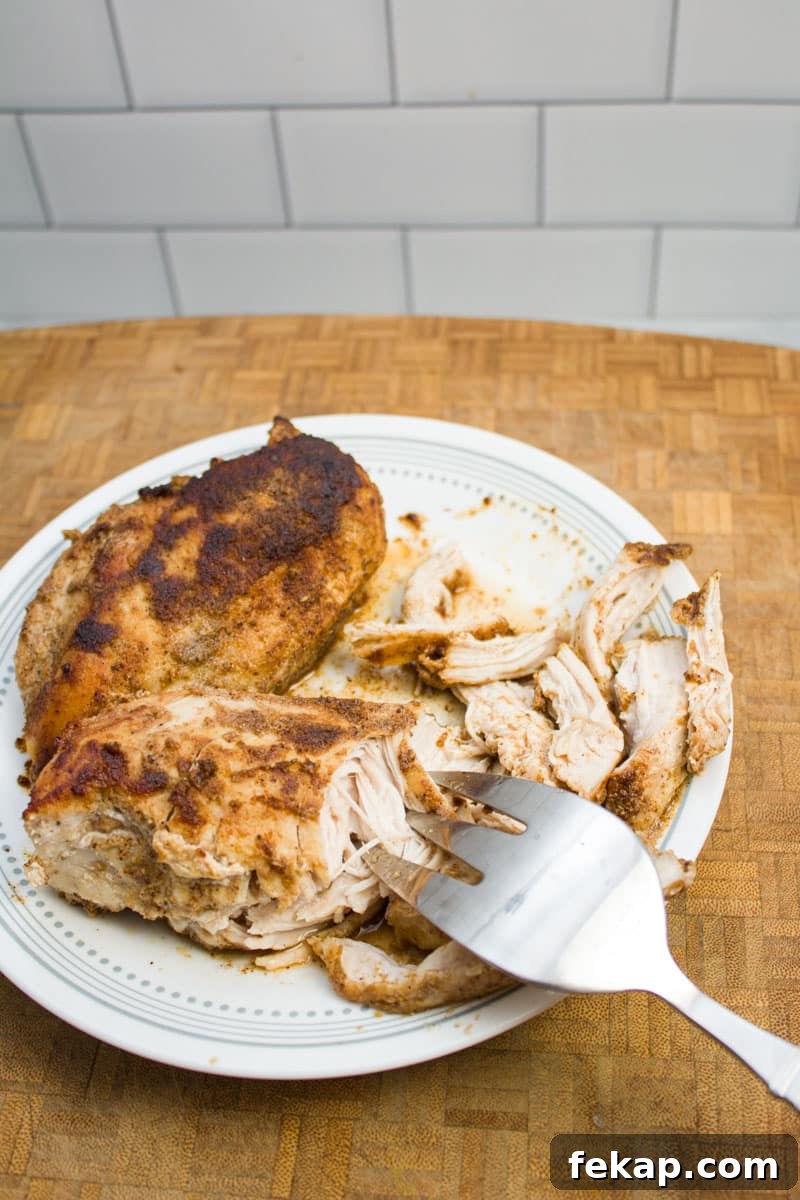 Shredding chicken with a fork.