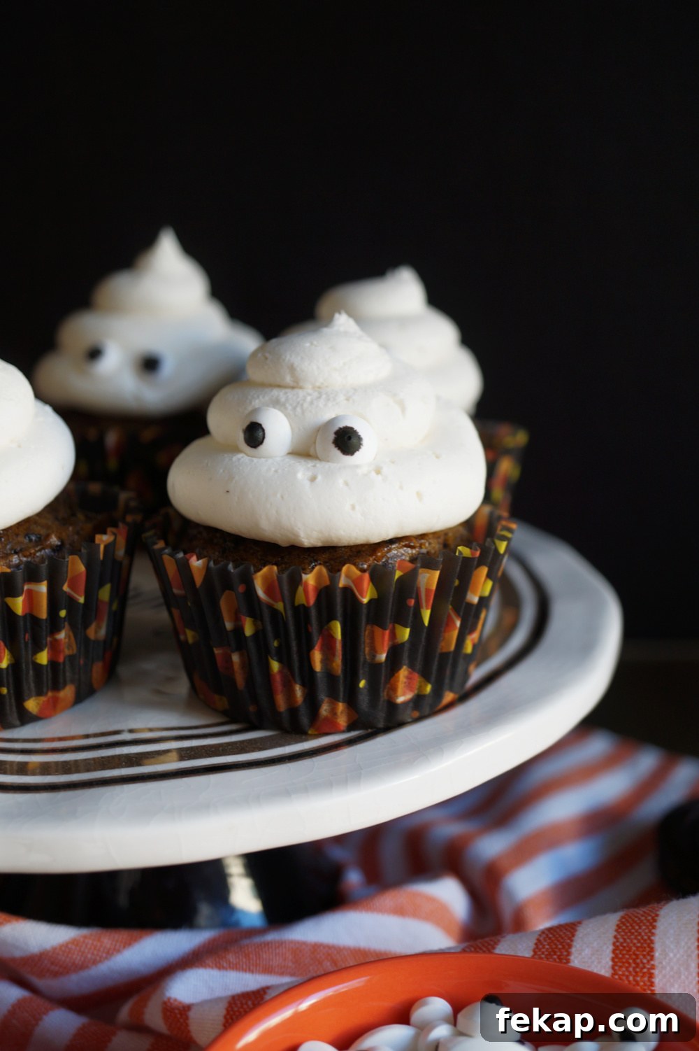 Vegan Oreo Pumpkin Cupcakes with Creamy Frosting 3 ghost cupcakes on cake stand