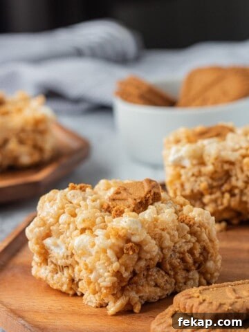 slice of cookie butter rice krispie treat on wood plate