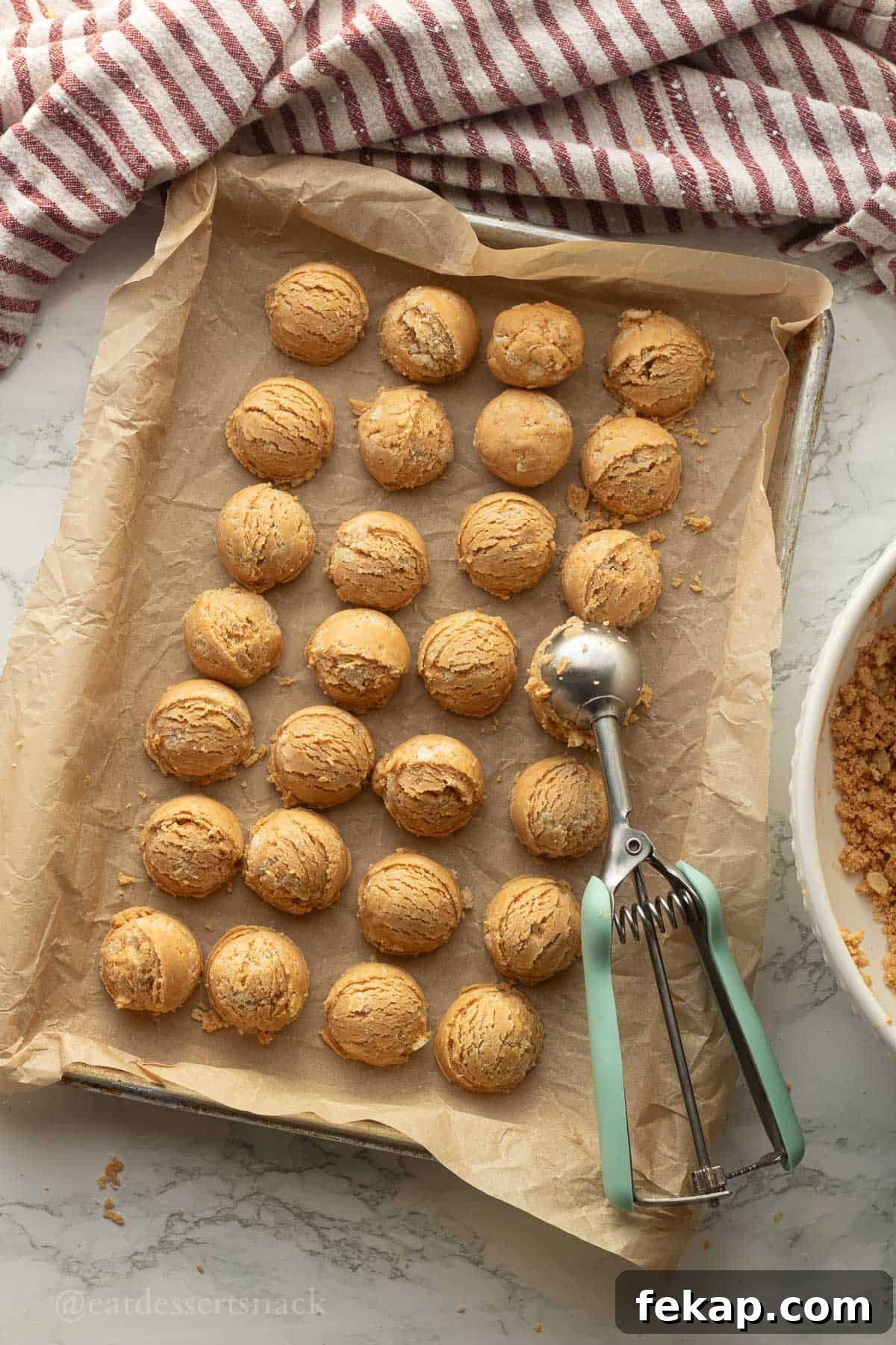 Scooped peanut butter balls on tray.