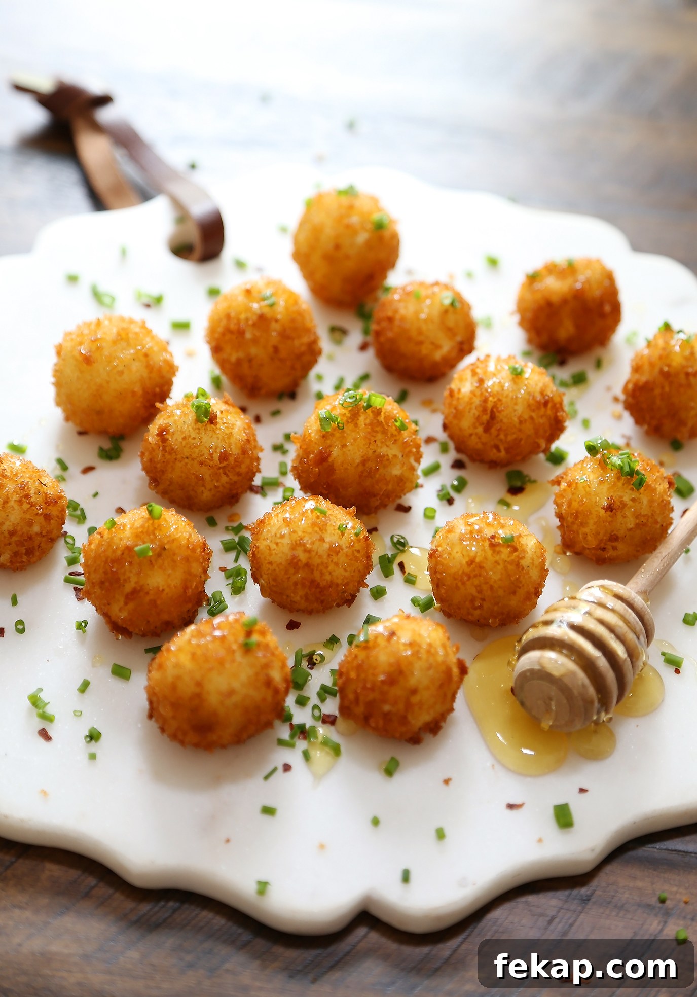 Crispy Goat Cheese Poppers with Honey Drizzle 2 Crispy goat cheese poppers with honey and fresh chives
