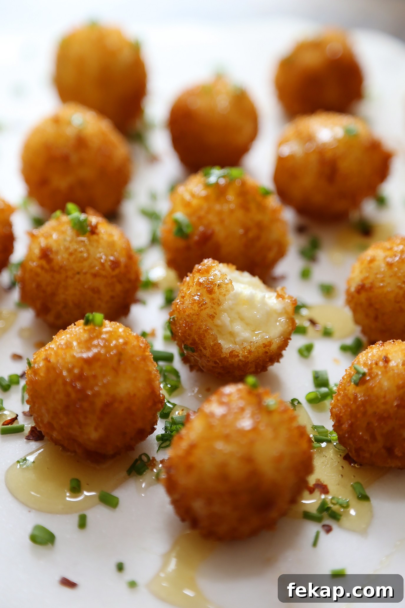 Crispy Goat Cheese Poppers with Honey Drizzle 6 Close-up of crispy fried goat cheese poppers with honey