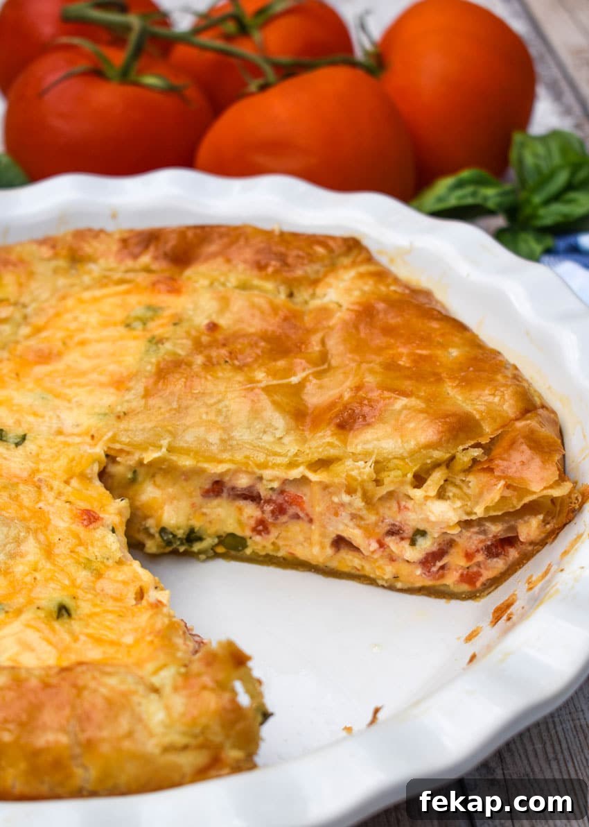 Savory Tomato Pie with Flaky Puff Pastry Crust 5 a tomato pie with puff pastry crust in a white pie dish