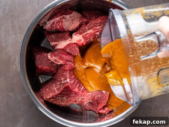 Korean BBQ Shredded Beef Burritos Recipe 4 pouring sauce over meat in instant pot