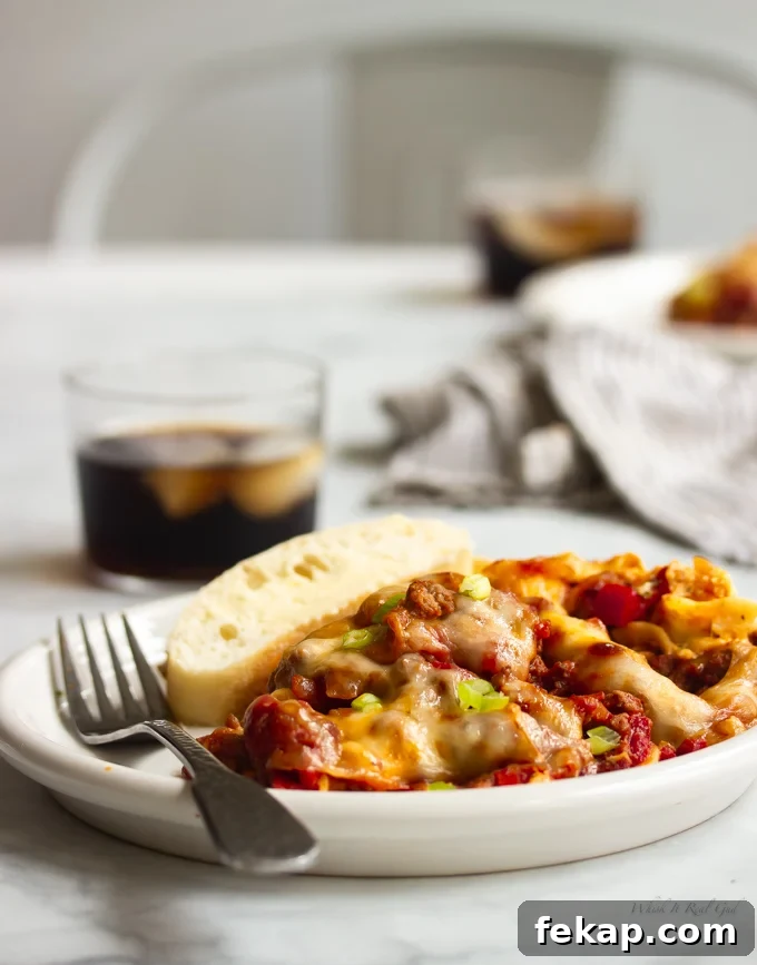 Ground beef casserole on a plate topped with green onions.