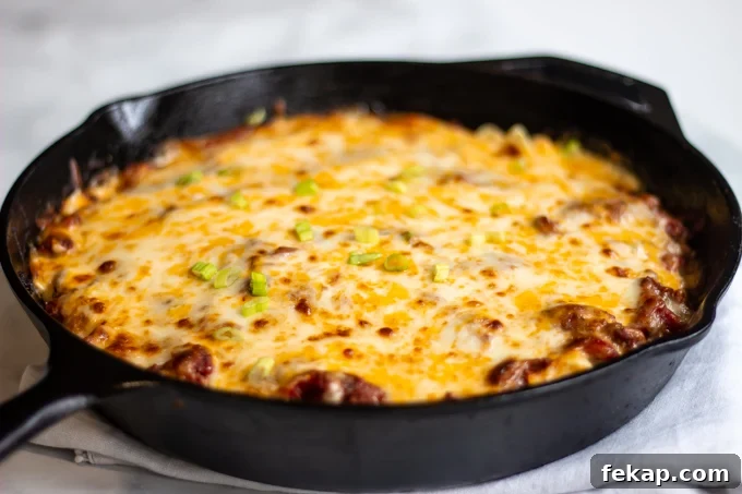 The finished cheesy hamburger casserole topped with sliced green onions