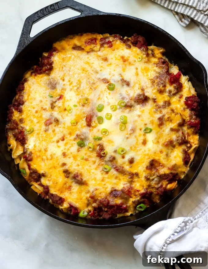Ground beef egg noodle casserole topped with melted cheeses