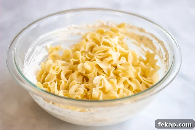 egg noodles with the cream cheese,sour cream and parmesan mixture.