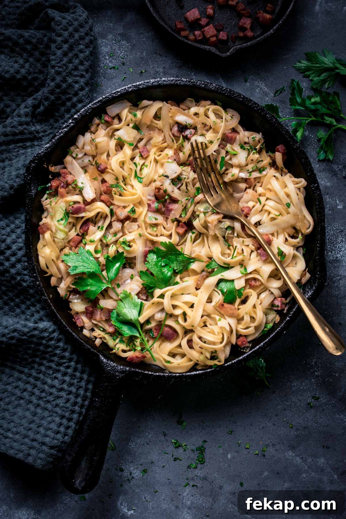 Classic Haluski: Fried Cabbage and Noodles with Bacon 2 Fried cabbage and noodles with crispy bacon in a skillet.
