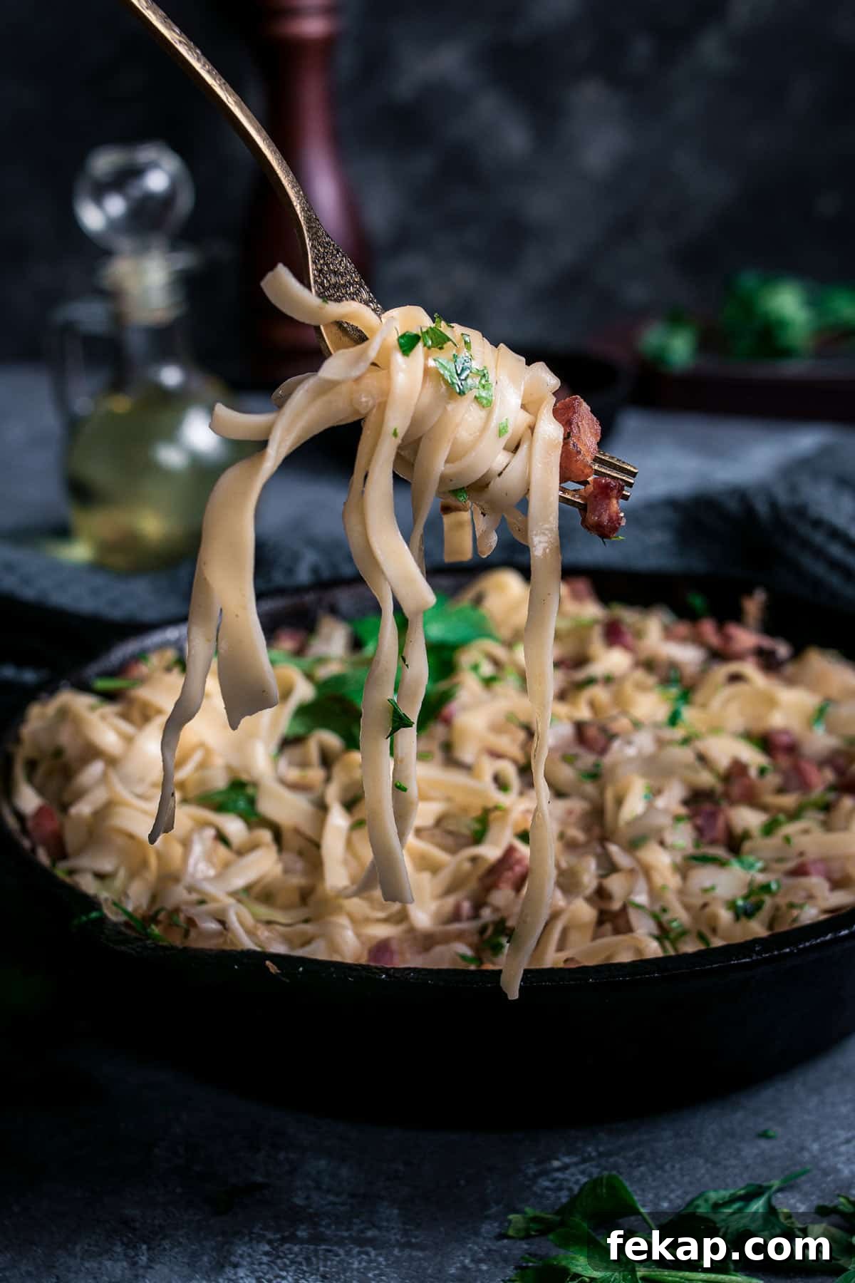 Classic Haluski: Fried Cabbage and Noodles with Bacon 10 Noodles with fried cabbage and bacon wrapped around a fork.