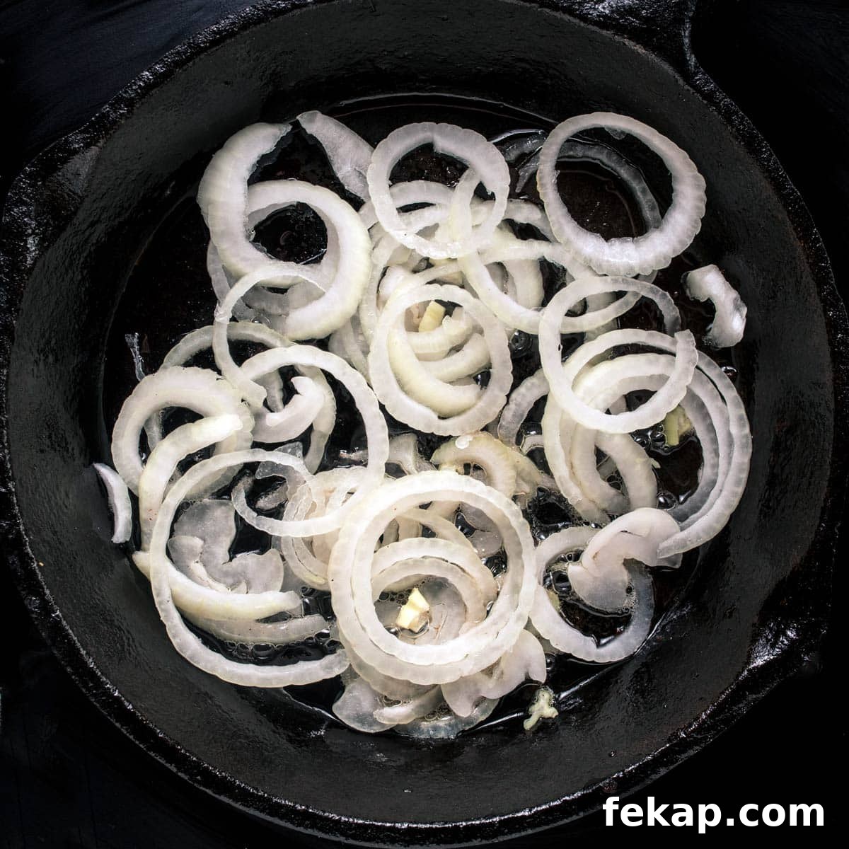 Classic Haluski: Fried Cabbage and Noodles with Bacon 5 Sautéing the onions in a skillet to make haluski.