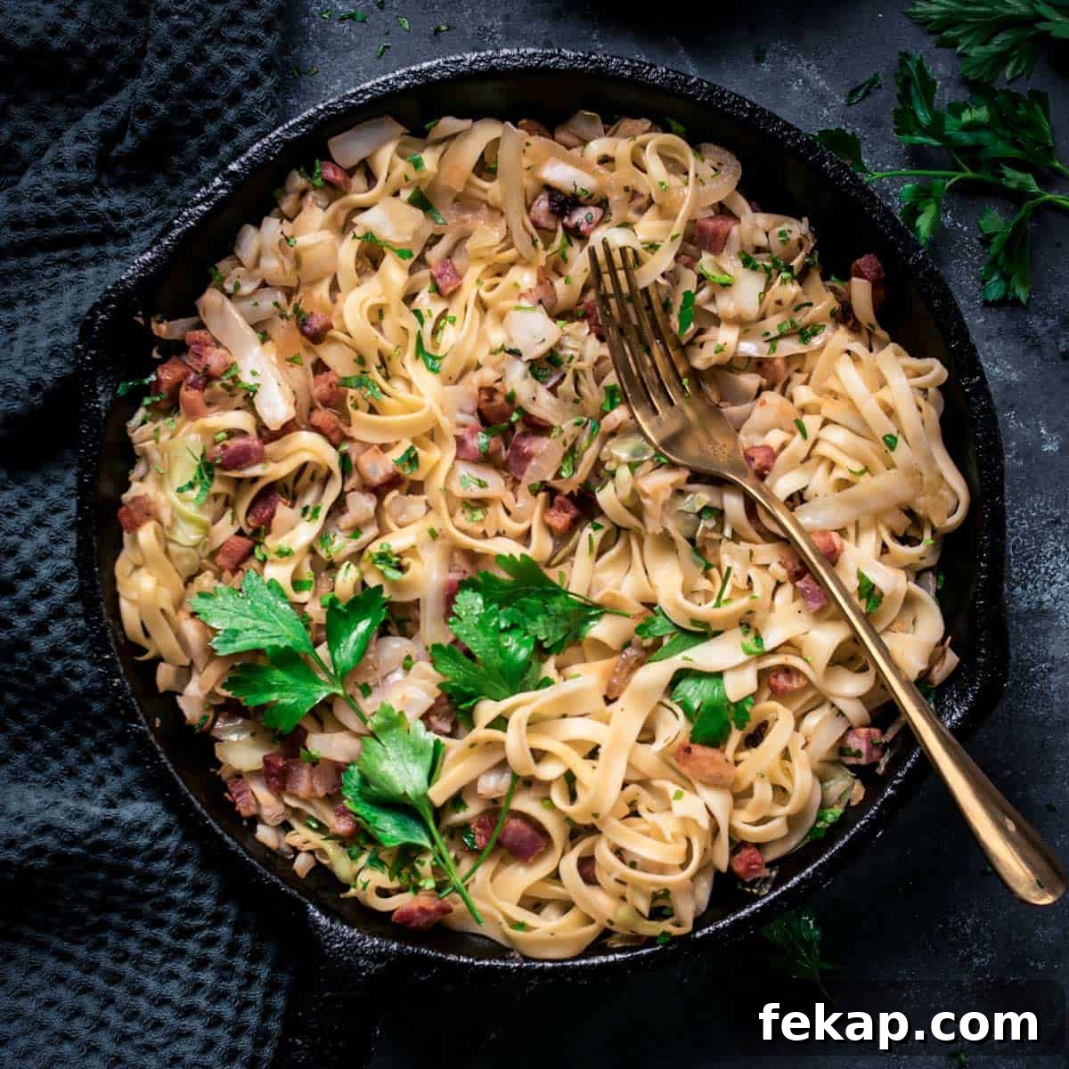 Classic Haluski: Fried Cabbage and Noodles with Bacon 8 Fried cabbage and noodles with bacon in a skillet with fork.