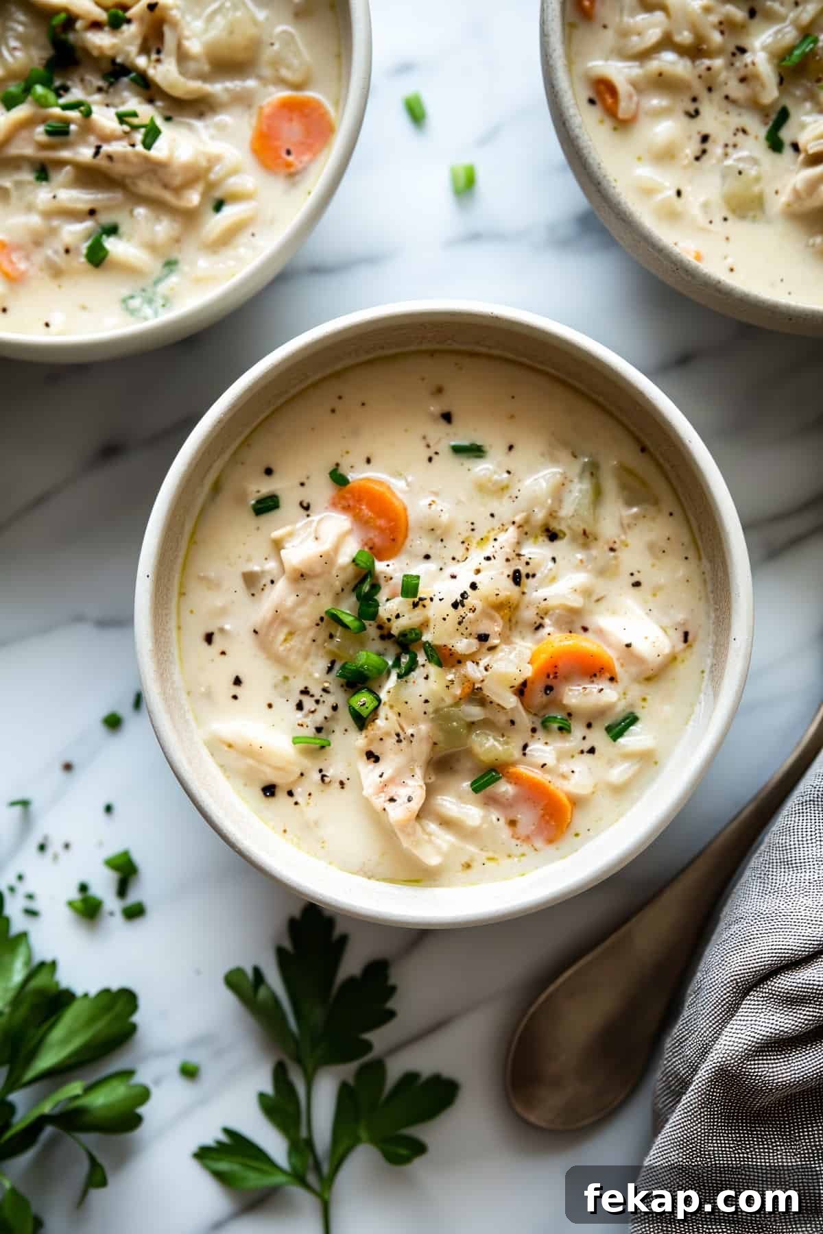 There's no better way to keep the fall wind at bay than to sit down and cozy up with this nourishing and hearty lightened up creamy chicken rice soup. Creamy chicken and rice soup with vegetables.