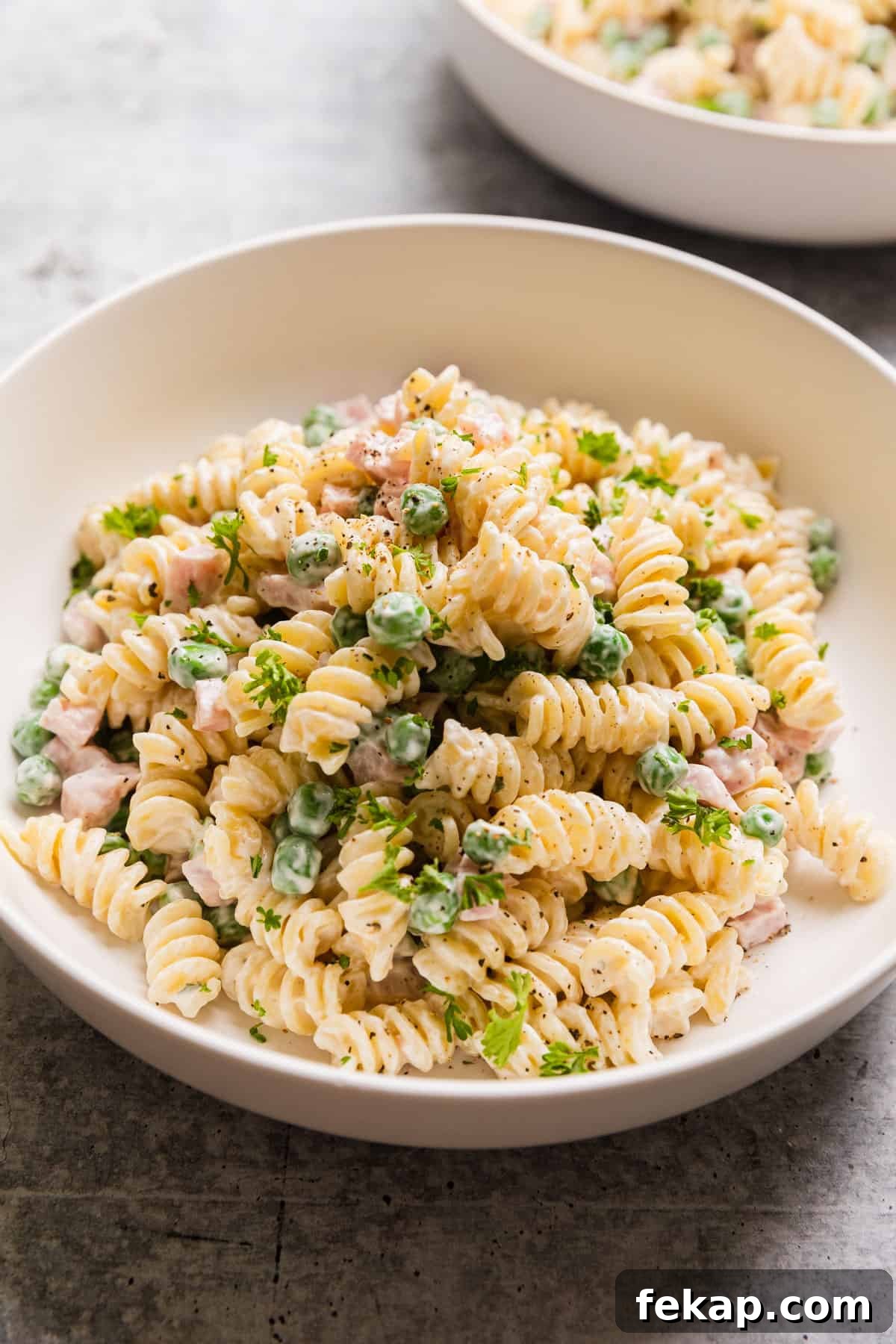 Copycat Ruby Tuesday Ham and Pea Pasta Salad Recipe 2 The completed ham and peas salad in a bowl.