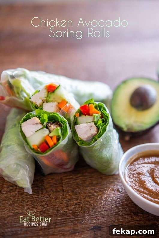 Chicken Avocado Spring Rolls cut in half on a board