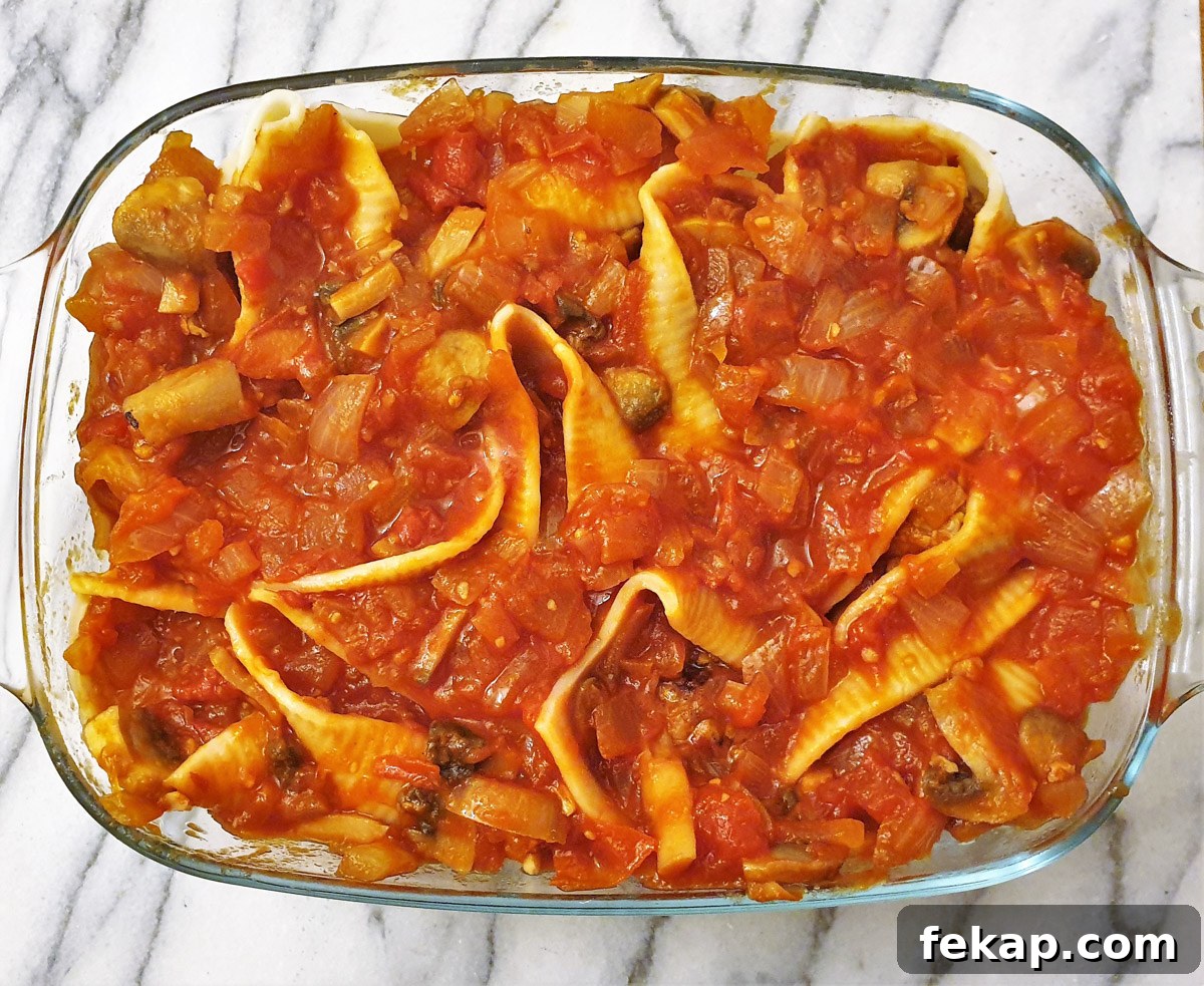 Baked Meatball Stuffed Shells in Spicy Tomato Sauce 2 A baking dish filled with jumbo pasta shells and meatballs, covered with homemade tomato sauce.