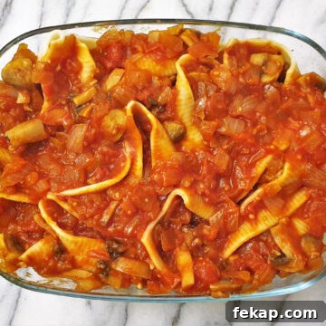 Baked Meatball Stuffed Shells in Spicy Tomato Sauce 8 A baking dish filled with jumbo pasta shells and meatballs, covered with homemade tomato sauce.
