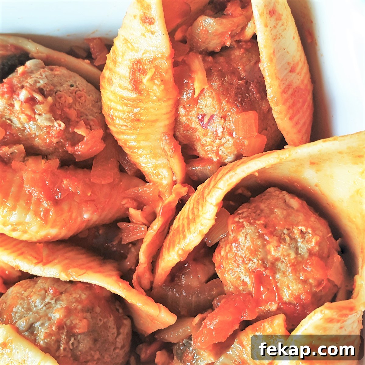 Baked Meatball Stuffed Shells in Spicy Tomato Sauce 3 Overhead shot of 4 meatballs in 4 jumbo pasta shells.