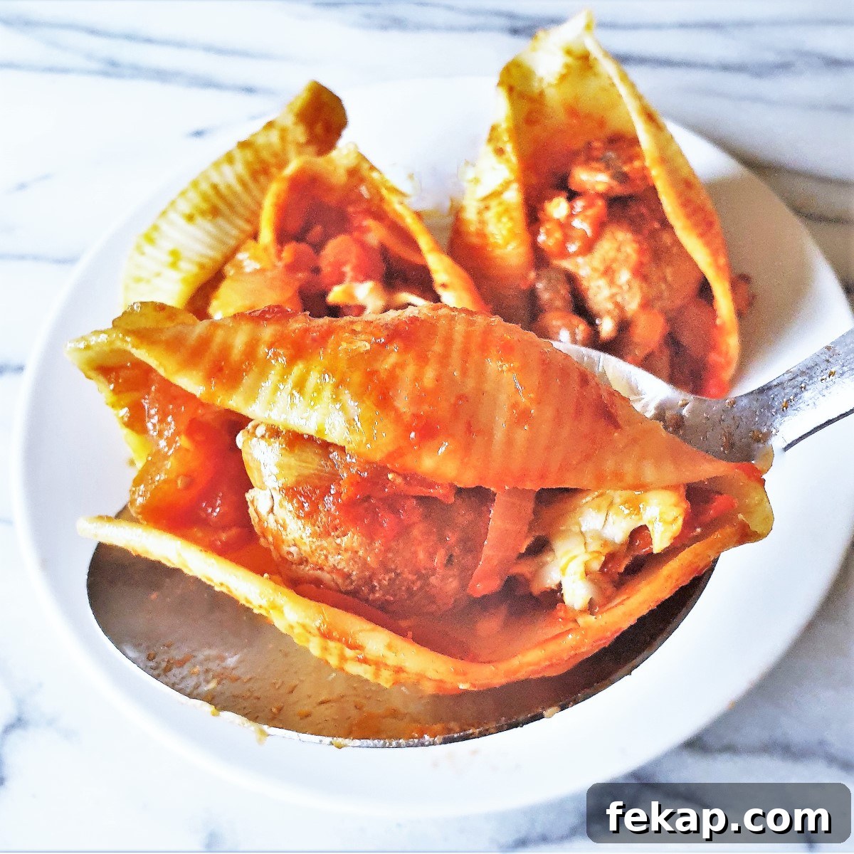 Baked Meatball Stuffed Shells in Spicy Tomato Sauce 7 Close up of meatballs in jumbo pasta shells.