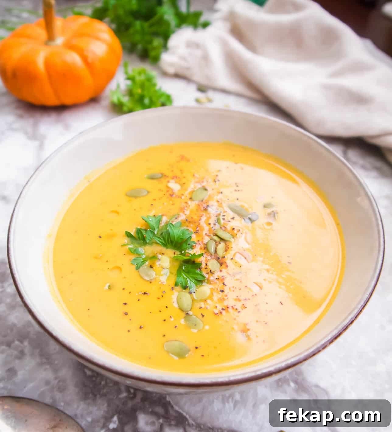 Roasted Pumpkin and Sweet Potato Soup Recipe 2 Pumpkin Sweet Potato Soup in a bowl with pumpkin seeds on top.