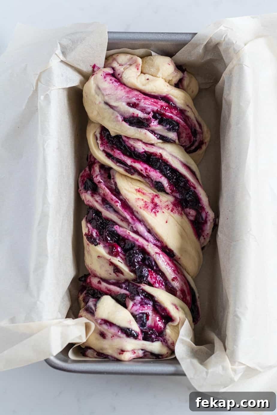 blueberry cream cheese babka in a loaf pan