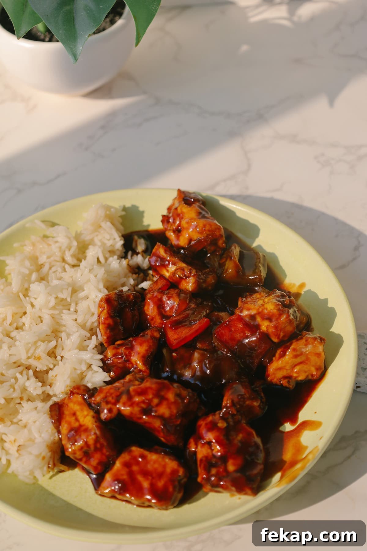 10 Tofu Recipes Meat Eaters Will Actually Love 12 Sweet and sour tofu with rice on a plate.