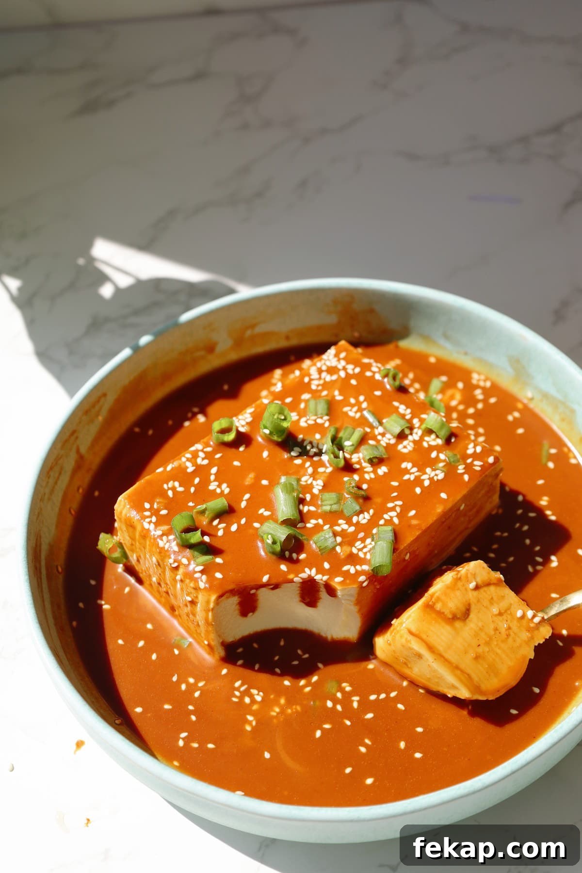 10 Tofu Recipes Meat Eaters Will Actually Love 3 Cold tofu recipe with gochujang peanut sauce on a plate.
