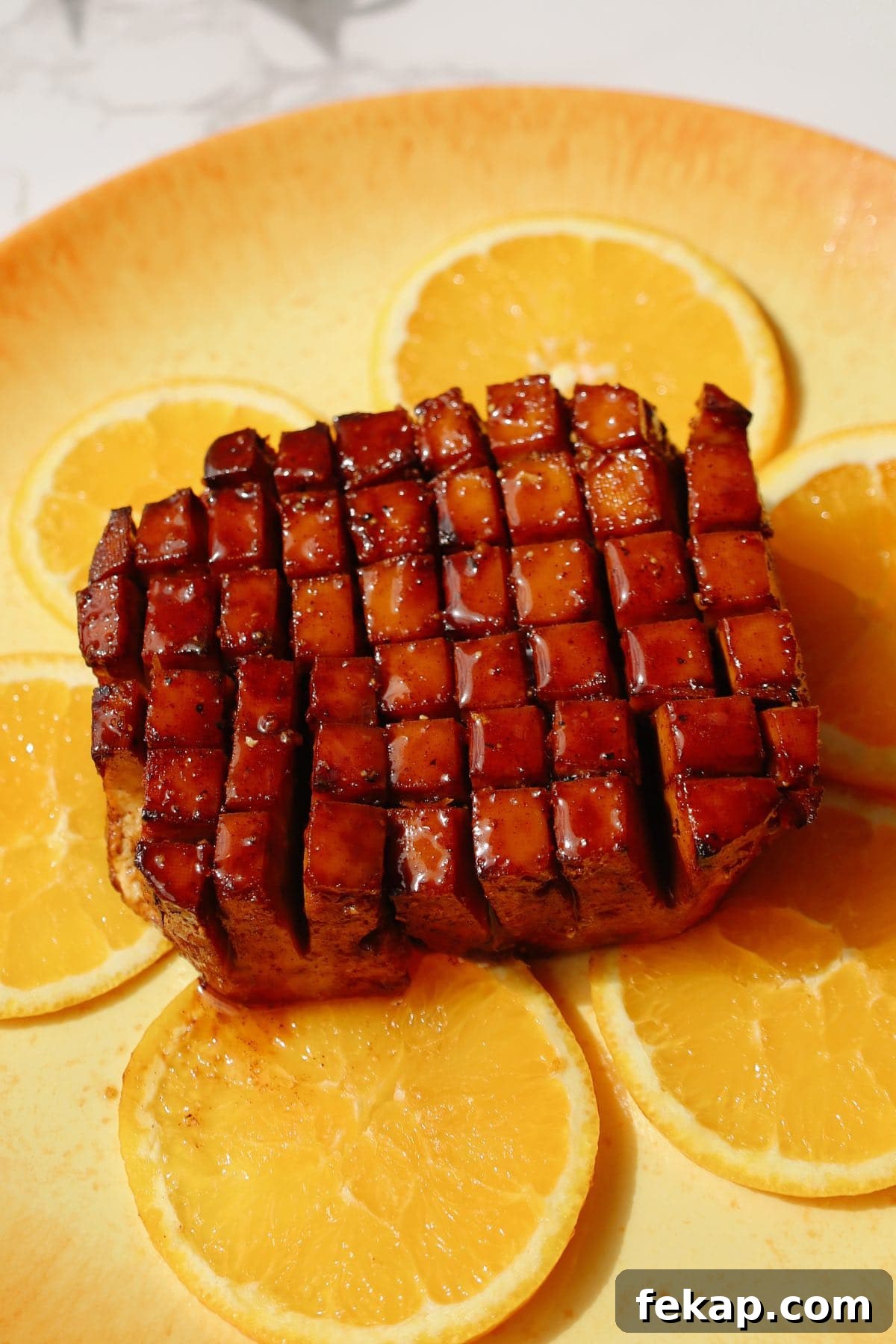 10 Tofu Recipes Meat Eaters Will Actually Love 4 Tofu ham on a plate with orange slices underneath.