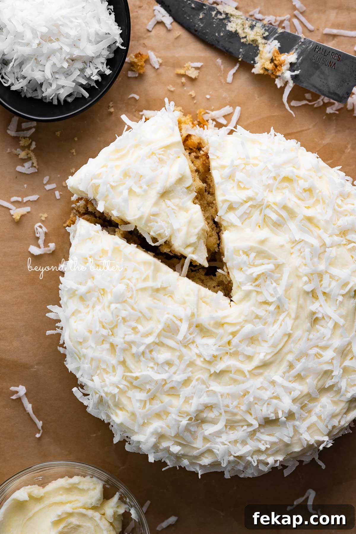 Moist Single Layer Coconut Cake Recipe 2 Single layer coconut cake frosted with coconut buttercream with slice cut out on natural parchment paper background | © Beyond the Butter®
