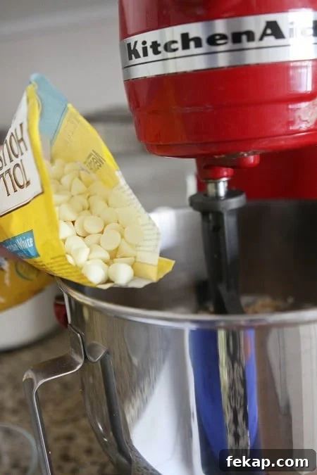 Image of White Chocolate Chips Being Added to The Bowl