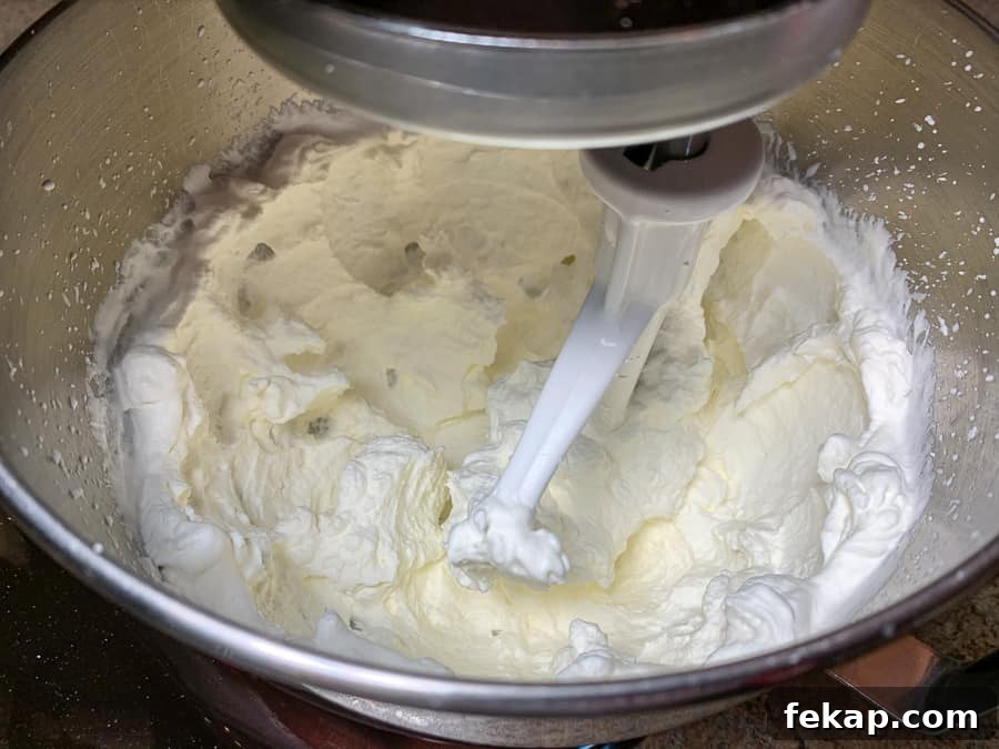 No-Bake Cherry Delight Recipe 8 Beating whipping cream in an electric mixer bowl