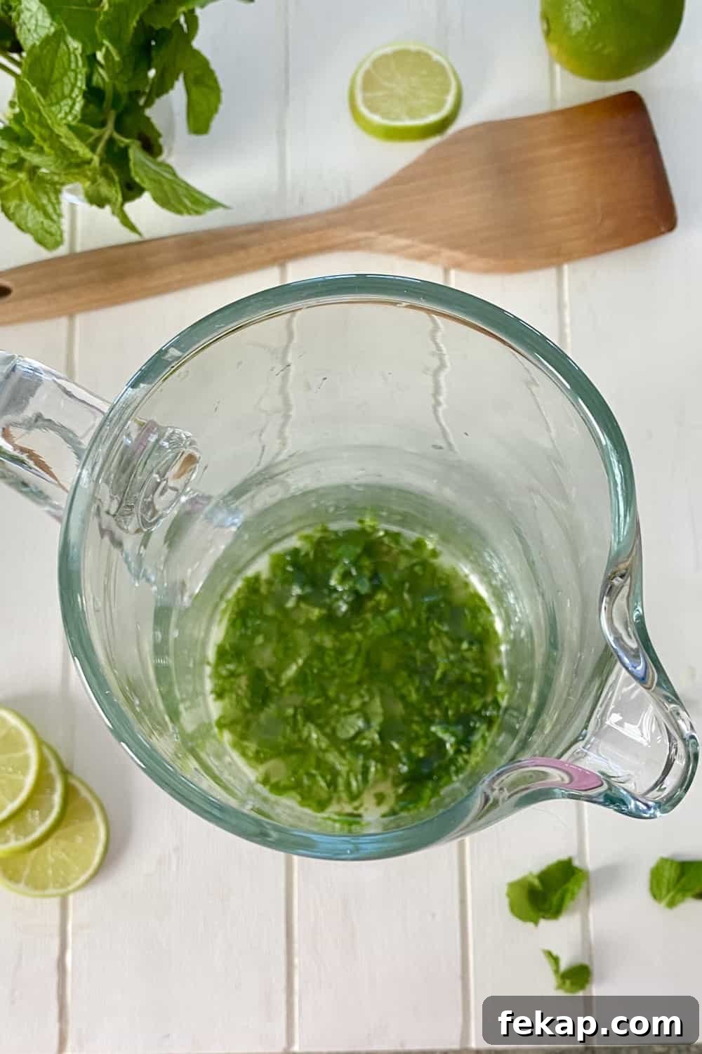 muddled mint leaves in a pitcher