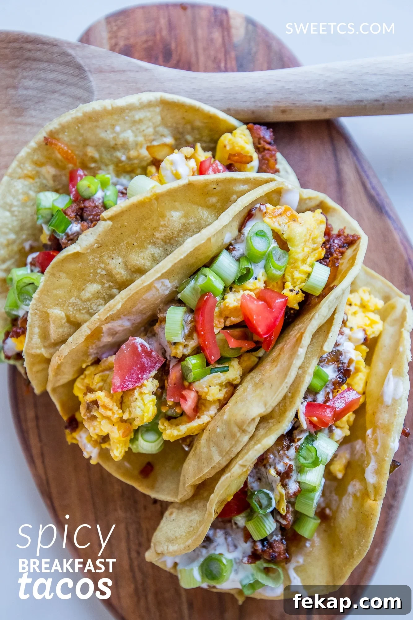 Chorizo Breakfast Tacos with Spicy Eggs 4 Tacos with eggs, green onions, tomatoes, and cheese in them